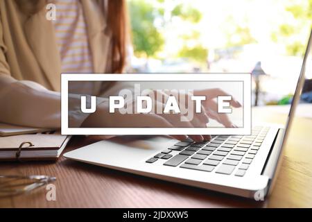 Junge Frau mit Laptop im Café, Nahaufnahme. Konzept aktualisieren Stockfoto