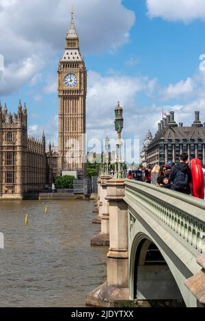 Elizabeth Tower, Big Ben, des Palace of Westminster, an der Westminster Bridge, London, Großbritannien. Überquerung der Themse. Menschen auf der Brücke Stockfoto