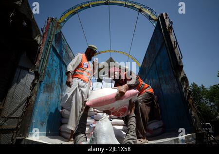 23. Juni 2022, Peshawar, khyber pakhtunkhwa, Pakistan: Mitarbeiter der Alkhidmat-Stiftung verladen Hilfsgüter auf Lieferwagen, um nach Chamkani nach afghanischen Erdbebenopfern zu versenden. Mehr als 1.000 Menschen wurden getötet und mehr als 1.500 weitere verletzt, nachdem ein Erdbeben der Stärke 5,9 vor Sonnenaufgang am 22. Juni Ostafghanistan getroffen hatte, berichtete die staatliche afghanische Nachrichtenagentur Bakhtar. Nach Angaben der Behörden dürfte die Zahl der Todesopfer steigen. (Bild: © Hussain Ali/Pacific Press via ZUMA Press Wire) Stockfoto