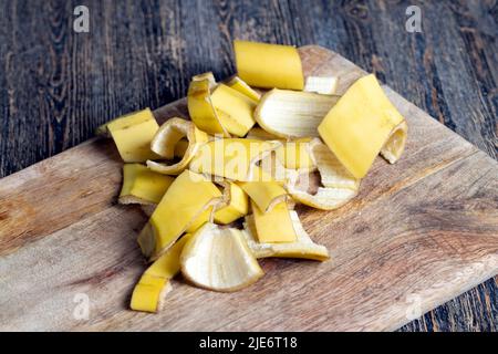 Die gelbe Schale, die nach den Bananen auf dem Brett zurückgelassen wurde, die leere Schale der Bananen, nachdem sie gereinigt wurden, das ist Müll Stockfoto