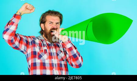 Bärtiger Mann schreit im Megaphon oder Lautsprecher. Ankündigung oder Verbreitung von Nachrichten. Protest. Eigene Meinung. Stockfoto