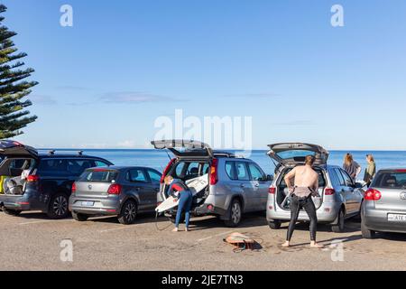 Der australische Surfer am Avalon Beach Sydney wechselt in seinen Neoprenanzug, um im Meer zu surfen, Sydney, NSW, Australien Stockfoto