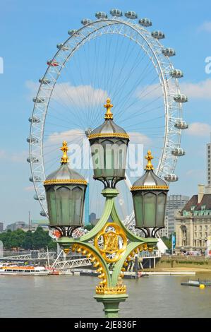 Themse und Nahaufnahme der historischen viktorianischen Straßenlaternen in einer Ansammlung auf einem verzierten Lampenpfosten aus Gusseisen, eingerahmt vom modernen London Eye Ferris Wheel UK Stockfoto