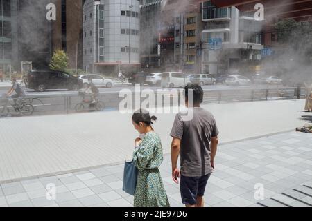 Tokio, Japan. 26.. Juni 2022. Menschen gehen auf einer Straße, während die Hitzewelle Tokio, Japan, trifft, 26. Juni 2022. Quelle: Zhang Xiaoyu/Xinhua/Alamy Live News Stockfoto