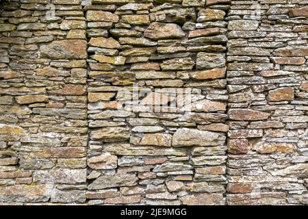 Die Überreste einer sehr alten Steinmauer eines verwelkenden Hauses in den Brecon Beacons in Südwales, Großbritannien Stockfoto