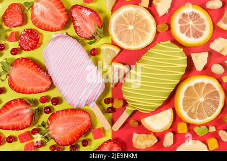 Zwei Eiscremes auf einem Stock - Erdbeere und Zitrone auf gelbem und rotem Hintergrund. Sommerliche Fruchtdesserts Stockfoto