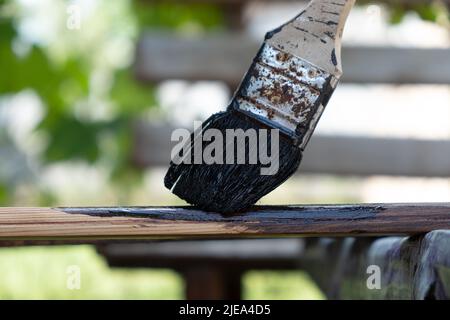 Die Lackierung der hölzernen Möbel für die Türen, färben die hölzerne Planke mit der Bürste. Stockfoto