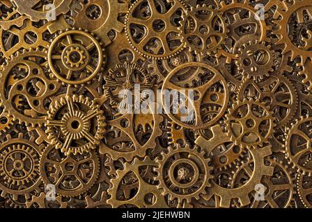 Große Gruppe von Zahnrädern aus Bronze, abstrakter Retro-Stil im industriellen Steampunk-Hintergrund Stockfoto