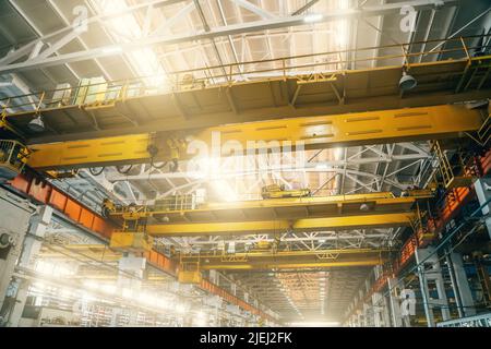 Gelbe Ober- oder Balken- oder Brückenkrane in der industriellen Metallverarbeitung Fabrik. Stockfoto