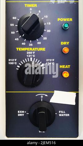 A control panel with buttons, knobs, and lights Stockfoto