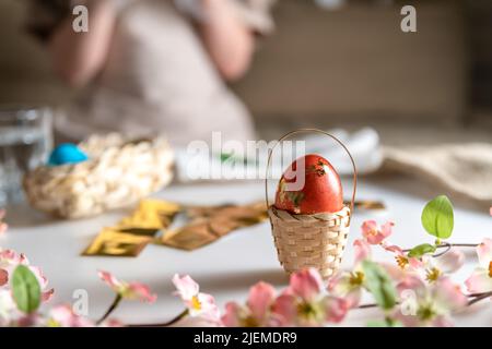 Mädchen zu Hause in der Küche färbt Eier für Ostern Stockfoto