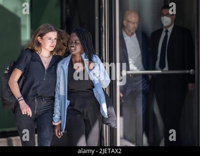 28. Juni 2022, Hessen, Frankfurt/Main: Die deutsche Klimaaktivistin Luisa Neubauer (l) von der Klimabewegung Fridays for Future verlässt die Deutsche Bank nach Gesprächen mit der Geschäftsführung des Unternehmens mit der ugandischen Aktivistin Evelyn Acham. Neubauer hatte mit Umweltaktivisten aus Uganda gegen die weitere Gewinnung fossiler Brennstoffe und den Bau einer Pipeline in Afrika protestiert. Foto: Boris Roessler/dpa Stockfoto