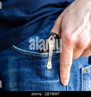 Mann hält das Messer in Handschuhen Stockfoto