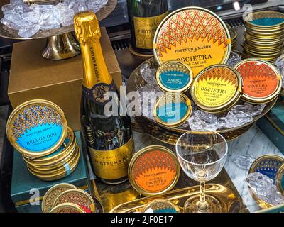 RUSSISCHER KAVIAR-CHAMPAGNER ZUM VERKAUF IN DER Fortnum & Mason Food Hall mit Vitrine der Kaviar-Sorten Beluga Oscietra Sevruga, Stockfoto
