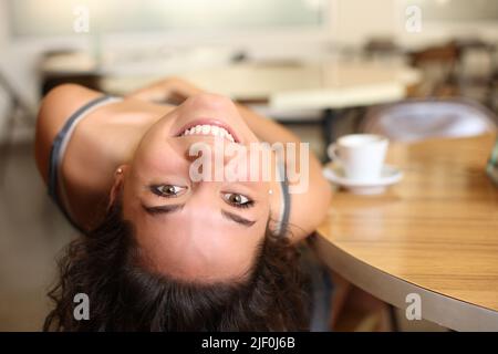 Lustiges Porträt einer glücklichen Frau, die in einer Bar scherzte und einen ansah Stockfoto