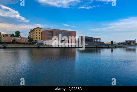 Ravenna, Italien: 10-04-2022: Wunderschöne Gebäude spiegeln sich an einem sonnigen Morgen auf Ravenna's darsena. Ein Dock ist ein abgetrennter Bereich mit Wasser, für den verwendet wird Stockfoto