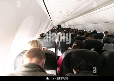 Passagiere in der Kabine, wenn sie am Himmel fliegen Stockfoto