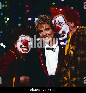 1, 2 oder 3, ZDF Quizshow für Kinder, moderiert von Biggi Lechtermann, hier mit den Verdinis Clowns im Zirkus Royal, Deutschland, 1986. 1, 2 oder 3, TV-Quizshow für Kinder, präsentiert von Biggi Lechtrmann, hier mit Verdinis Clowns im Circus Royal, Deutschland, 1986. Stockfoto