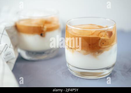 Zwei Gläser Dalgona eiskalten Kaffee auf dem Tisch. Stockfoto