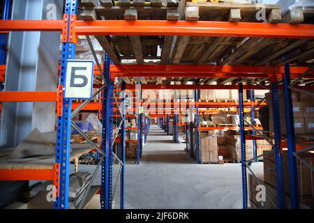 Auf einem Regal im Lager angeordnete Waren und Materialien. Lagerbestände. Industrielager. Lager einer Handelsorganisation. Stockfoto