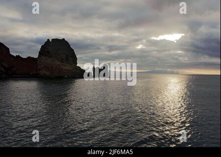 Die großen Inseln im Galapagos-Archipel, Isabela, sind in der Ferne zu sehen. Im Vordergrund befinden sich Inselchen vor Santiago in der Nähe der Buccaneer Cove. Stockfoto