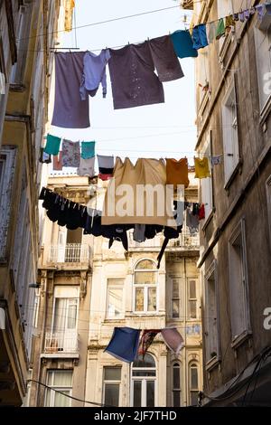 Istanbul – Hängen zwischen Gebäuden auf einer schmalen Straße im Viertel Hacimi in Beyoglu, Istanbul, Türkei Stockfoto