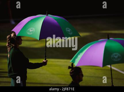 London, Großbritannien, 30.. Juni 2022: Mitarbeiter halten Sonnenschirme als Sonnenschutz im All England Lawn Tennis and Croquet Club in London. Kredit: Frank Molter/Alamy Live Nachrichten Stockfoto