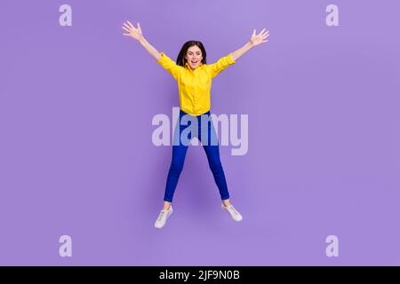 In voller Länge Körpergröße Ansicht der attraktiven fröhlichen verrückten Mädchen springen Narren isoliert über helle violett lila Farbe Hintergrund Stockfoto