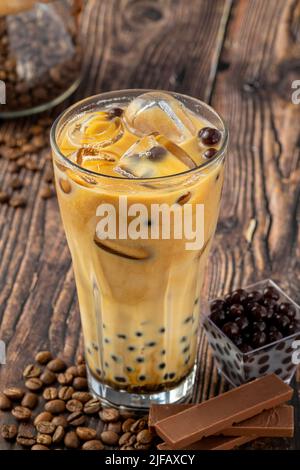 Bubble Tee mit Kaffee und Schokolade in Glas Tasse auf dunklem Hintergrund. Stockfoto