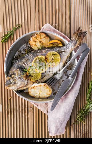 Köstlicher gegrillter dorado-Fisch mit Zitrone und Petersilie. Ganze BBQ-Seebrasse gebacken. Dorado Grill. Ketogen, Keto oder Paläo-Diät Mittagessen, gesunde Ernährung Trend Stockfoto