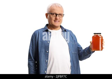 Casual reifer Mann hält ein Glas Honig isoliert auf weißem Hintergrund Stockfoto