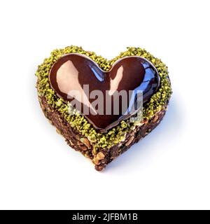 Herzförmiger Valentinskuchen, dunkle Schokolade, Pistazie Stockfoto