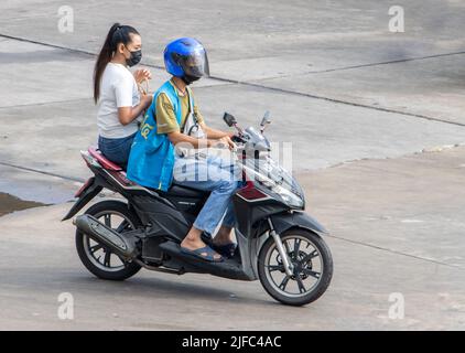 SAMUT PRAKAN, THAILAND, 28 2022. MÄRZ, Ein Taxifahrer auf einem Motorrad fährt mit einer Frau. Stockfoto