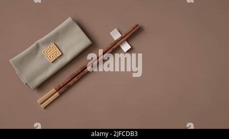 Eine Darstellung von braunen Holzstäben und Serviette aus dem Jahr 3D auf einer braunen Oberfläche Stockfoto