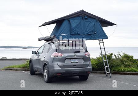 Auf einem Parkplatz am Wasser auf Vancouver Island, British Columbia, Kanada, wird ein Dachzelt aufgestellt Stockfoto