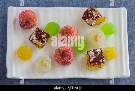 Verschiedene Teller Agra Angoori Petha - Schokolade, Pfanne, Kokosnuss, Kesar, Pista Geschmack auf dunklem Hintergrund. Nahaufnahme von süß aus Agra, Uttar Pradesh Indien. Stockfoto