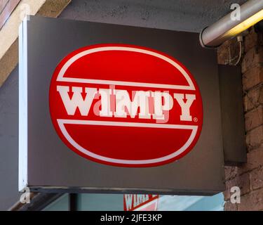 Norfolk, Großbritannien - 8. 2022. April: Nahaufnahme des Wimpy-Logos über dem Eingang des Restaurants in der Marktstadt Kings Lynn in Norfolk, Großbritannien. Stockfoto