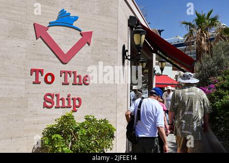 Kusadasi, Türkei - Juni 2022. Mai: Schild an der Wand des Kreuzfahrtterminals zeigt Passagieren den Weg zu ihrem Schiff. Stockfoto