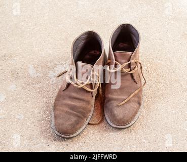 Braune Schuhe auf Betonboden Stockfoto