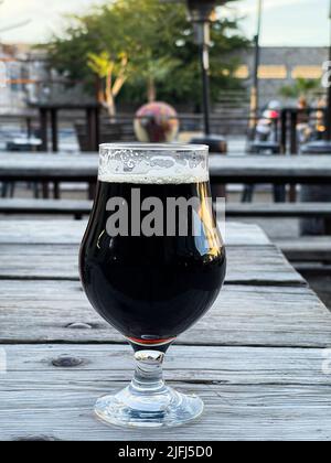 Glasbecher mit Craft-Bier von Cerveceria la Ruina dunkel, braun auf Holztisch in Hermosillo, Mexiko. © (Foto von Luis Gutierrez/Norte Photo) copa de cristal con cerveza artesanal de Cerveceria la Ruina color oscura, color Cafe sobre mesa de madera en Hermosillo, Mexiko. © (Foto von Luis Gutierrez/Norte Photo) Stockfoto