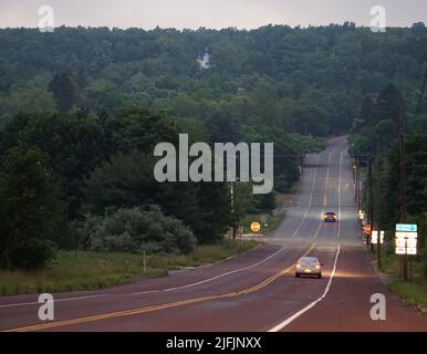 Centralia, USA. 17.. Juni 2022. Bei Einbruch der Dunkelheit fahren einige Autos in der Geisterstadt Centralia entlang einer Straße. Ein Kohlefeuer hatte die einst blühende Stadt im US-Bundesstaat Pennsylvania in eine Geisterstadt verwandelt. (Um dpa zu berichten: „Geisterstadt über einem Inferno“) Quelle: Benno Schwinghammer/dpa/Alamy Live News Stockfoto