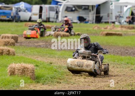 Heddington, Wiltshire, Großbritannien. 3.. Juli 2022. Rennbegeisterte treten 2022 bei der Lawn Mower Racing World Championship an. Die jährliche zweitägige Veranstaltung wird von der British Lawn Mower Racing Association (BLMRA) organisiert und fand in diesem Jahr auf der Heddington & Stockley Steam Rally & County Fair in Wiltshire, Großbritannien, statt. Kredit: Alison Eckett / Alamy Stockfoto