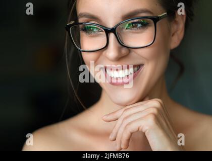 Nahaufnahme einer glücklichen lächelnden Frau in einer Brille. Gesundheitskonzept für das Sehvermögen. Stockfoto