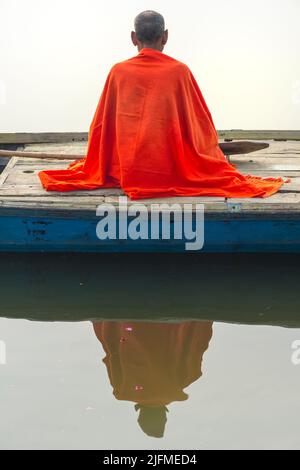 Sadhu mit rotem Schal auf einer Bootsfahrt auf dem Ganges bei Sonnenaufgang, Allahabad Kumbh Mela, der weltweit größte religiöse Versammlung, Uttar Pradesh, Indien Stockfoto