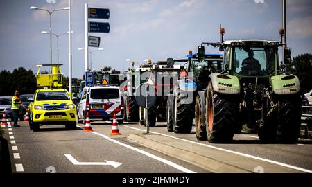2022-07-04 14:40:34 HAPERT - die Polizei ist auf der A67 in der Nähe von Eindhoven anwesend, um in einen Bauernprotest einzugreifen. In Hapert wurde die Straße von mehreren landwirtschaftlichen Fahrzeugen blockiert, aber nach Angaben der Polizei bewegt sich der Verkehr wieder dorthin. ANP ROB ENGELAAR niederlande aus - belgien aus Stockfoto