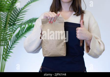 Barista Frau mit Kaffeebohnenverpackung Stockfoto