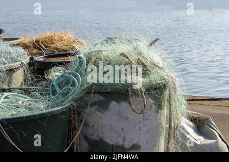 Plastikfischernetze in großen Bottichen am Kai im Hafen an der Ostsee, Kopierraum, ausgewählter Fokus, enge Schärfentiefe Stockfoto