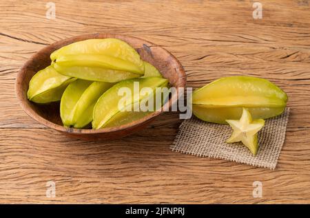 Starfruits in einer Schüssel über einem Holztisch. Stockfoto