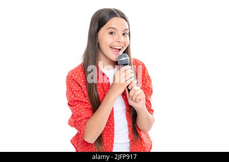 Hübsches kleines Mädchen, das mit dem Mikrofon singt. Porträt der emotionalen erstaunt aufgeregt Teenager-Mädchen. Porträt von glücklich lächelnd Teenager-Kind Mädchen. Stockfoto