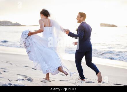 Ich freue mich auf jahrelange Abenteuer an deiner Seite. Aufnahme eines jungen Paares am Strand an ihrem Hochzeitstag. Stockfoto